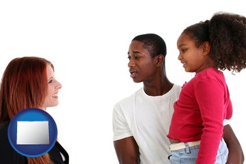 a social worker conversing with clients - with Colorado icon